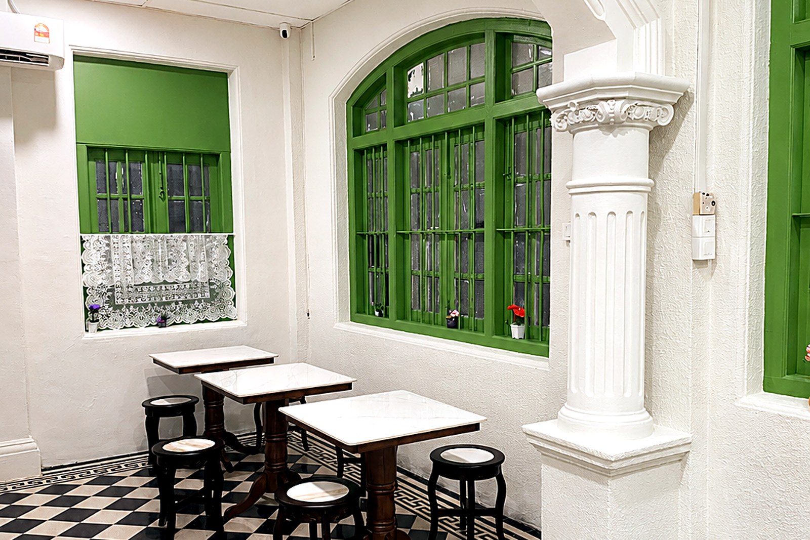 A café-style corner with marble-top tables and stools, good for working