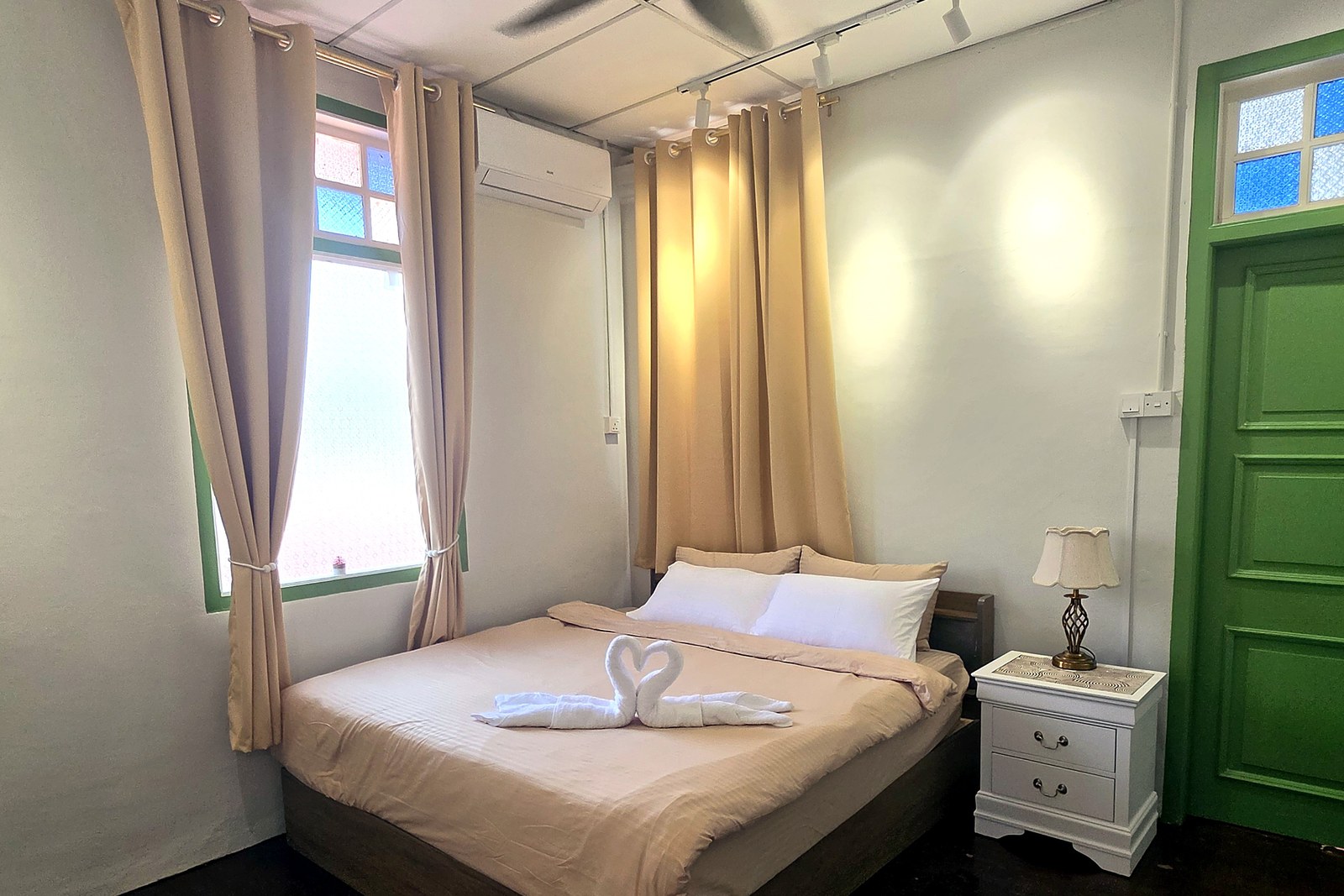 A quiet private room in soft neutral tones with a green door
