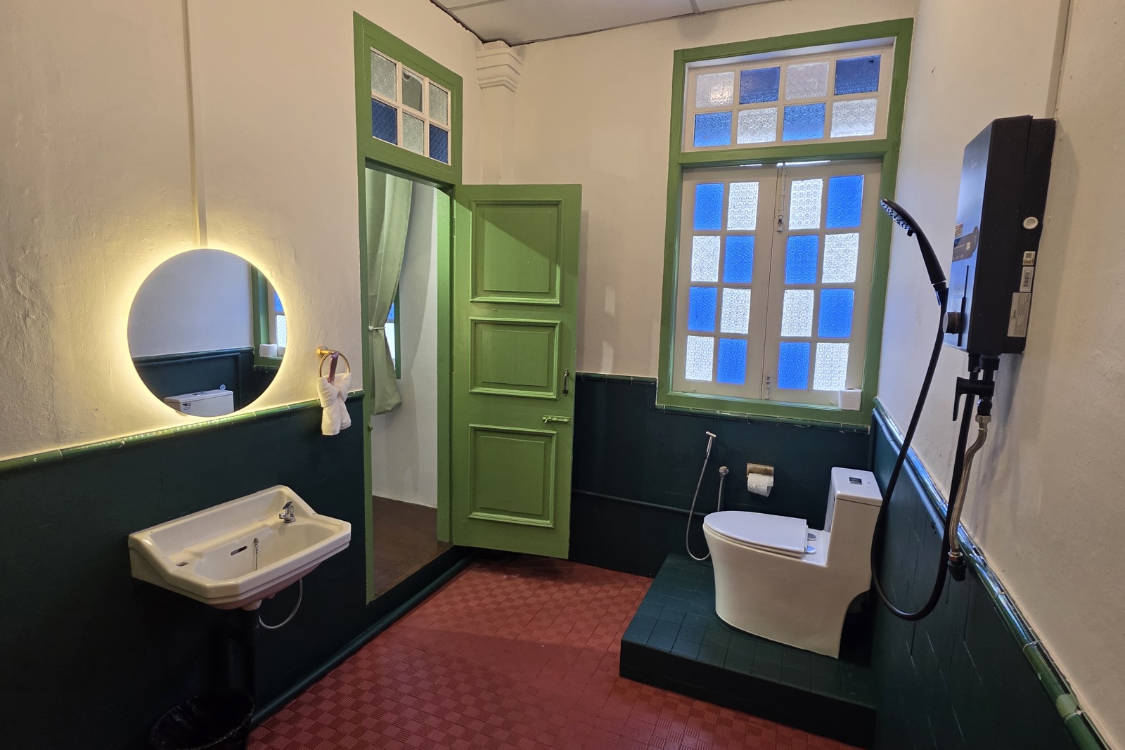 Green-tiled guest bathroom
