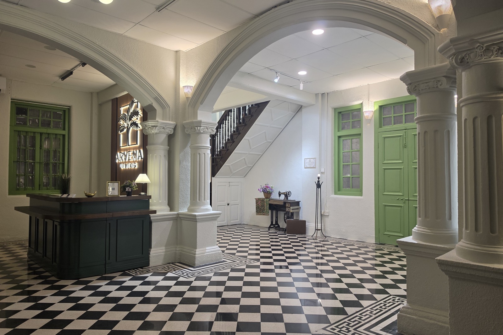 Spacious Arvena Living reception hall with heritage arches and checkerboard floor